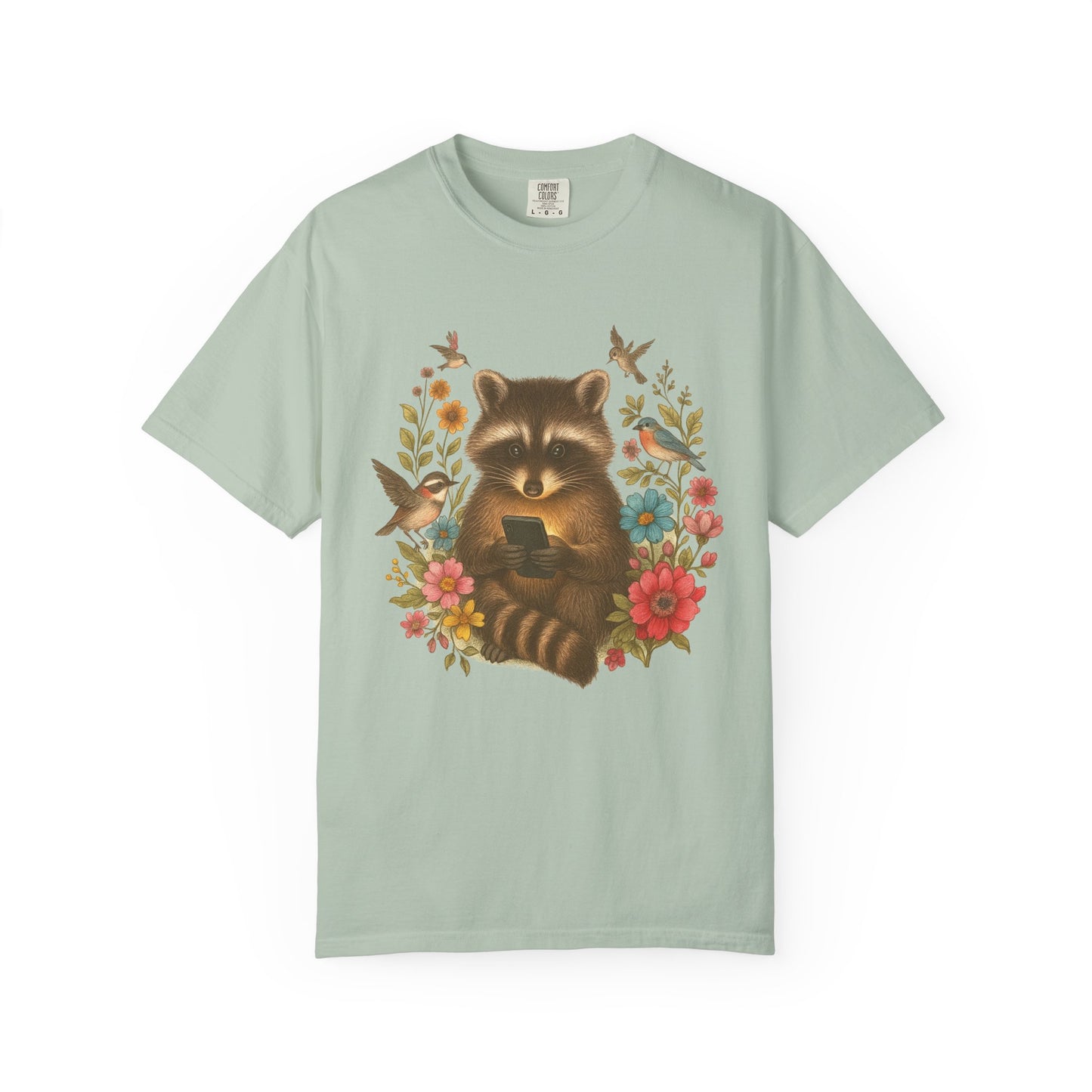 T-shirt design showing raccoon holding phone surrounded by colorful wildflowers and birds