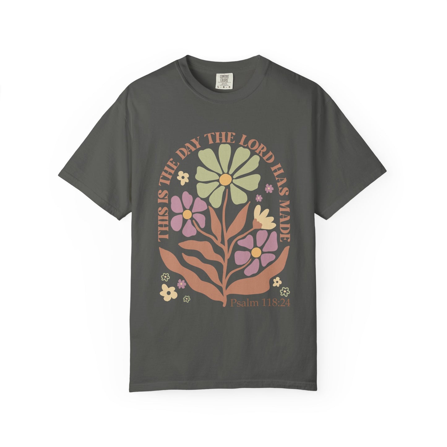 T-shirt with 'This is the Day' text, Psalm 118:24 verse, and floral design with protective hands in sage green, pink, and terracotta colors