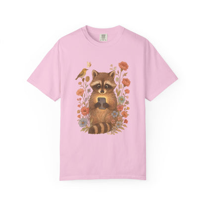 T-shirt with cute raccoon holding smartphone surrounded by coral and blue wildflowers