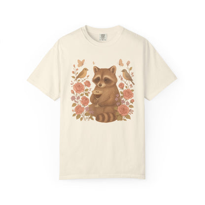 T-shirt with raccoon holding espresso martini glass surrounded by pink roses and birds