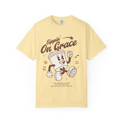 Christian t-shirt with cartoon coffee cup character and 'Sippin' On Grace' text in brown design