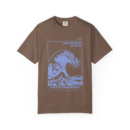 T-shirt with blue ocean wave design featuring 'Ride The Wave Of Faith' and 'Faith Unshaken' text