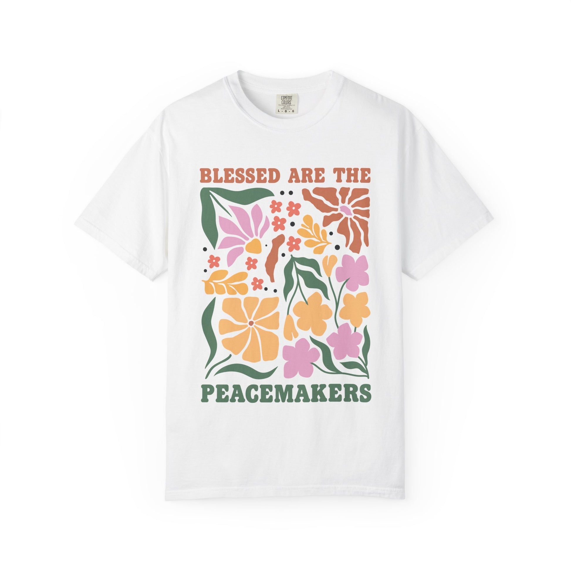 T-shirt with 'Blessed Are The Peacemakers' text surrounded by colorful floral design in pink, coral, yellow and green