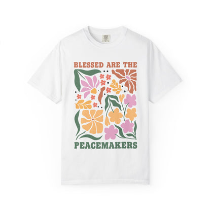 T-shirt with 'Blessed Are The Peacemakers' text surrounded by colorful floral design in pink, coral, yellow and green