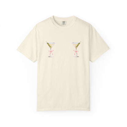 T-shirt design with two martini glasses containing olives and pink bow details creating a humorous cocktail theme