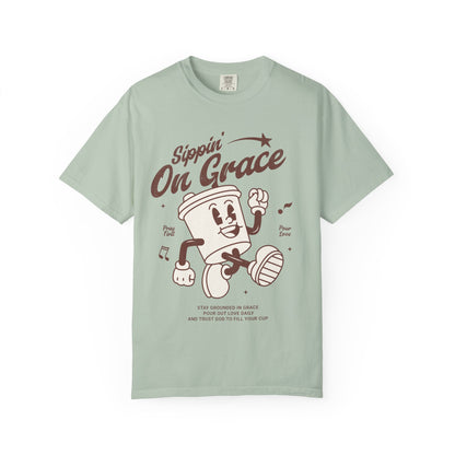 Christian t-shirt with cartoon coffee cup character and 'Sippin' On Grace' text in brown design