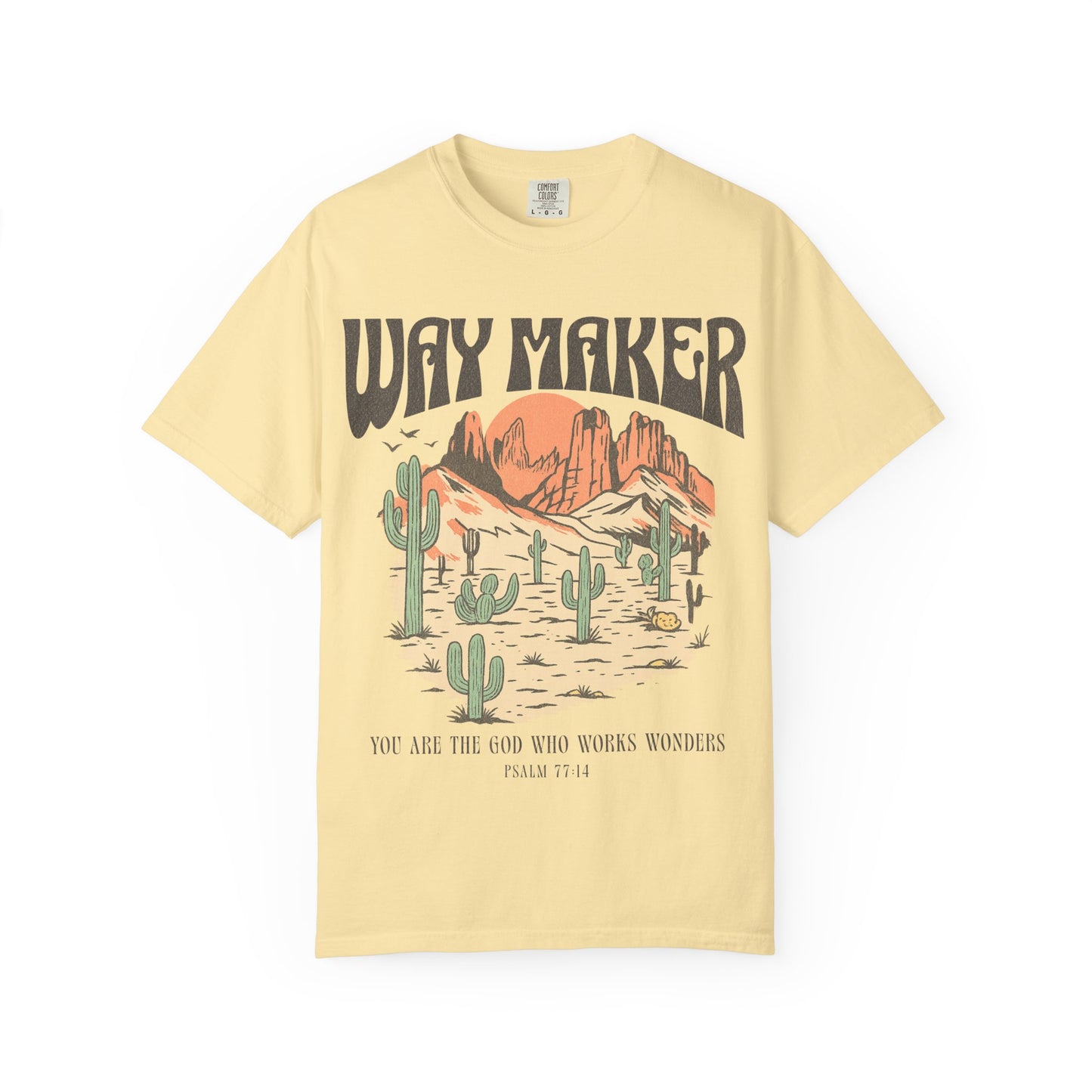T-shirt with Way Maker text, desert landscape featuring cacti, mountains, and orange sunset with Psalm 77:14 verse