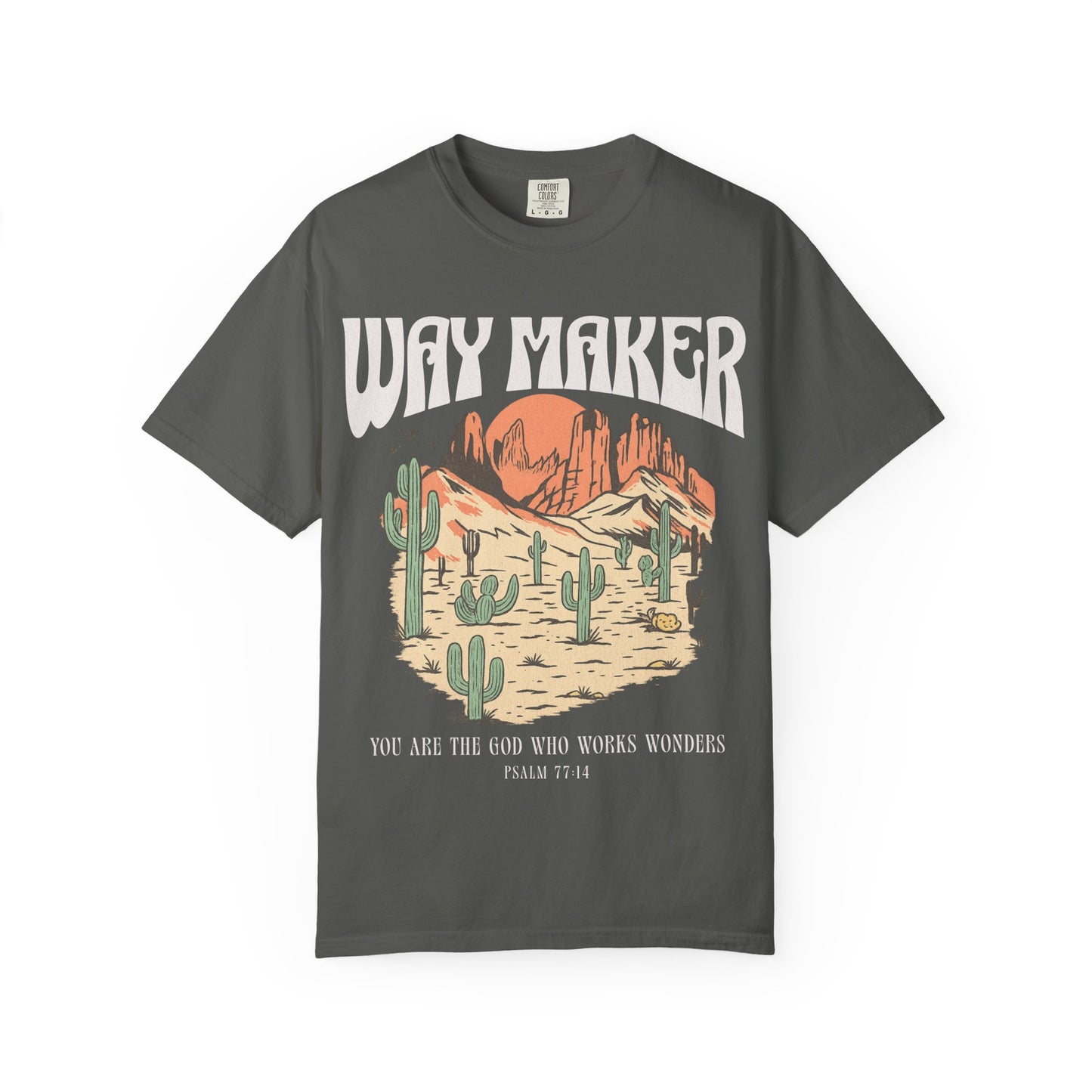 T-shirt with Way Maker text, desert landscape featuring cacti, mountains, and orange sunset with Psalm 77:14 verse