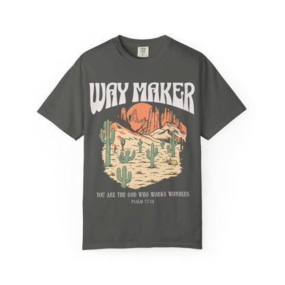 T-shirt with Way Maker text, desert landscape featuring cacti, mountains, and orange sunset with Psalm 77:14 verse