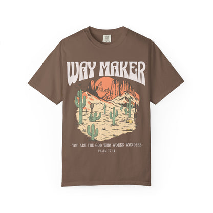 T-shirt with Way Maker text, desert landscape featuring cacti, mountains, and orange sunset with Psalm 77:14 verse