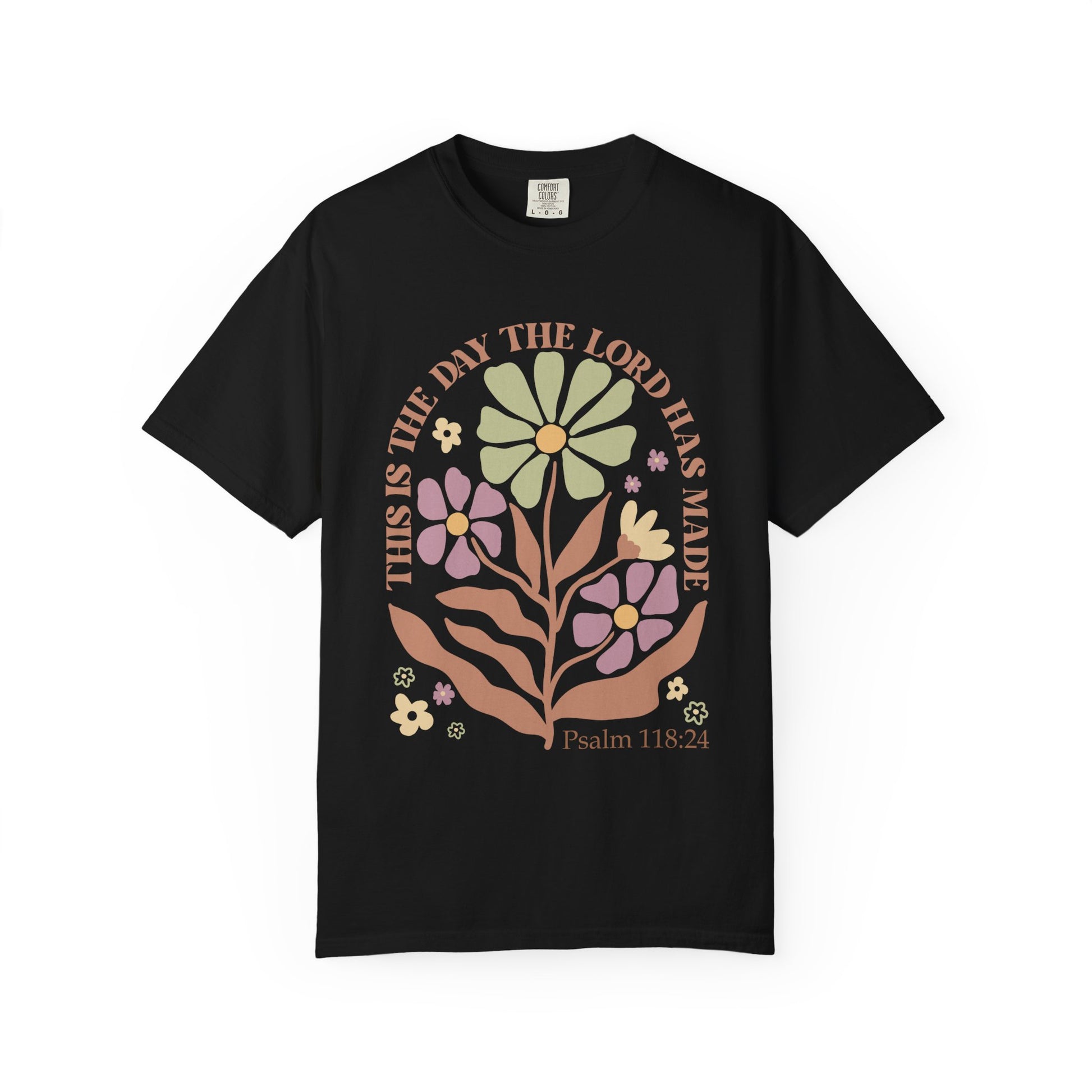 T-shirt with 'This is the Day' text, Psalm 118:24 verse, and floral design with protective hands in sage green, pink, and terracotta colors