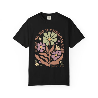T-shirt with 'This is the Day' text, Psalm 118:24 verse, and floral design with protective hands in sage green, pink, and terracotta colors
