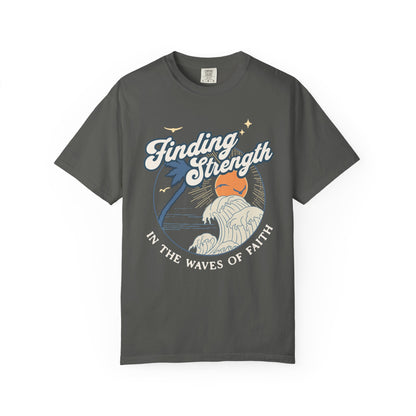 T-shirt with retro Christian design featuring palm tree, sunset, and ocean waves with Finding Strength text