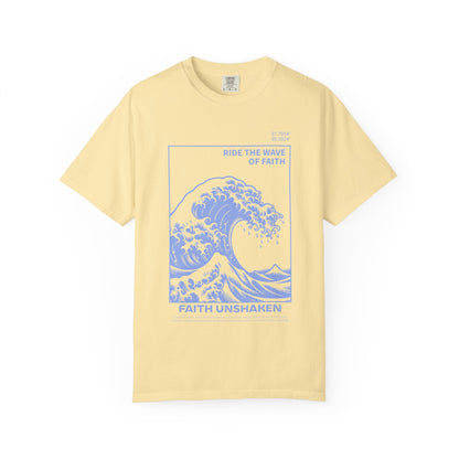 T-shirt with blue ocean wave design featuring 'Ride The Wave Of Faith' and 'Faith Unshaken' text