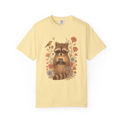 T-shirt with cute raccoon holding smartphone surrounded by coral and blue wildflowers