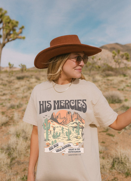 Christian t-shirt with desert landscape design featuring 'His Mercies Are New Each Morning' text and Lamentations 3:23 verse