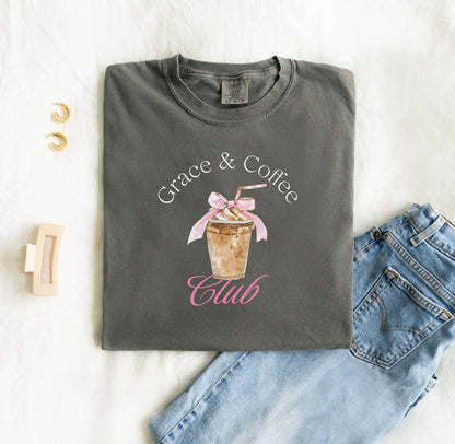 T-shirt with watercolor coffee cup design featuring pink bow and Grace & Coffee Club text