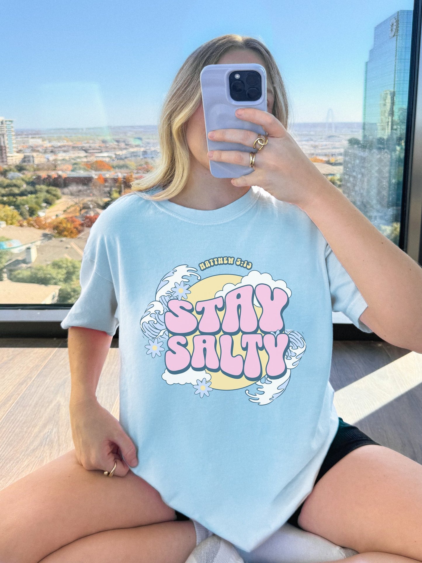 T-shirt with wavy font Stay Salty Matthew 5:13 text in pink bubble letters with ocean waves and flowers