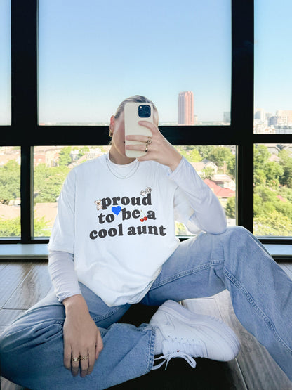 T-shirt with retro distressed text 'proud to be a cool aunt' decorated with teddy bear, blue heart, dice, and cherries