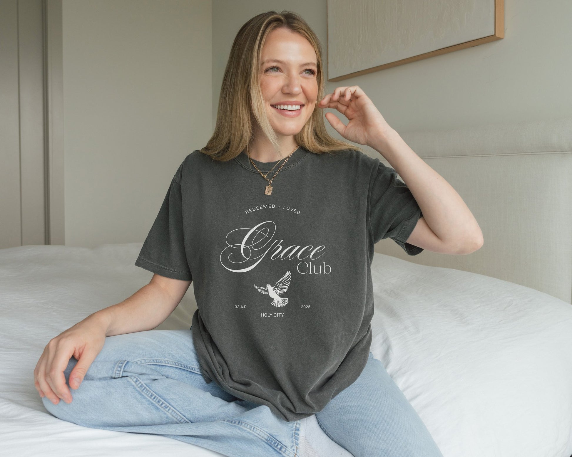 T-shirt with Grace Club text, dove symbol, and Redeemed + Loved message in elegant green design