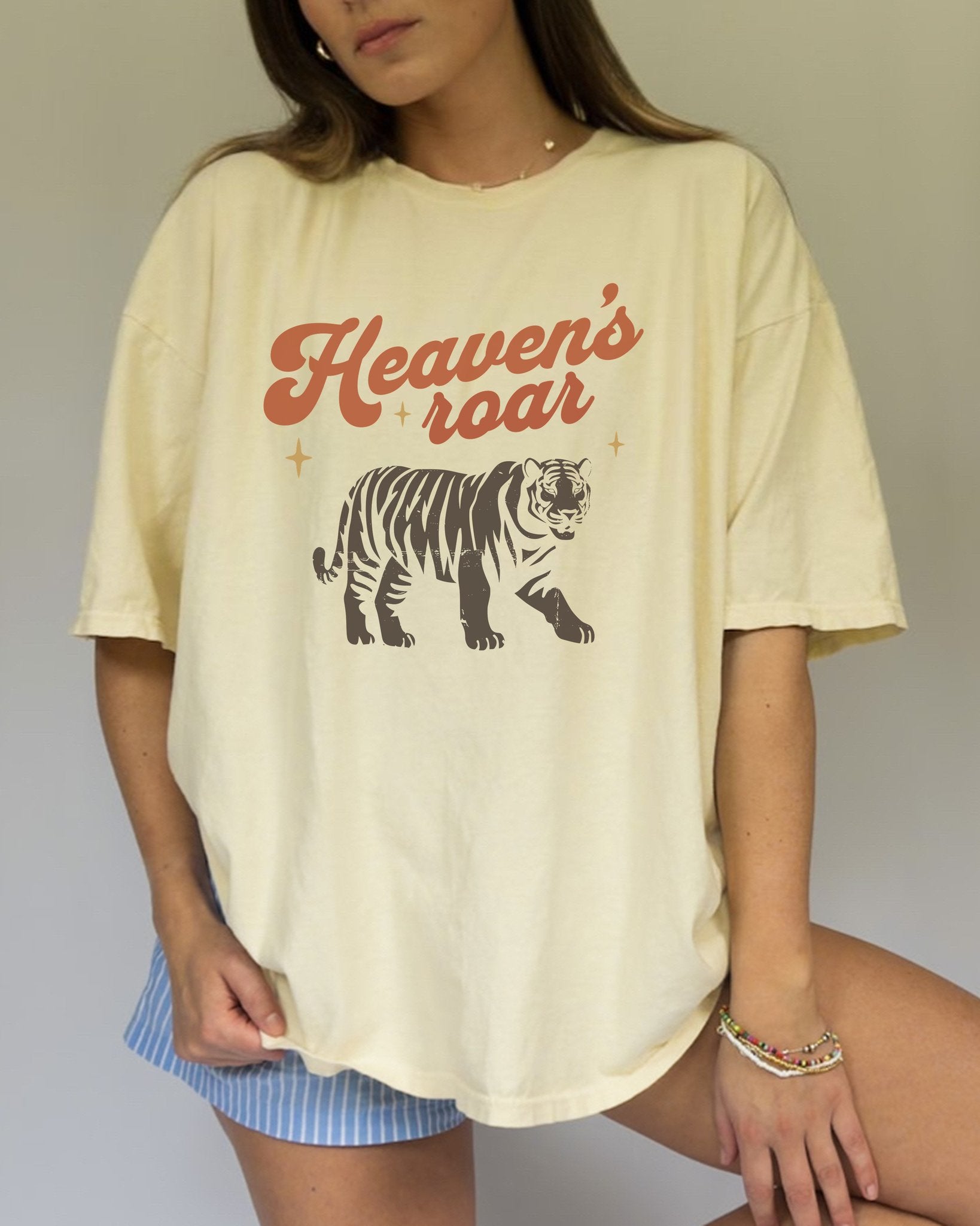 Christian t-shirt with Heaven's roar text in orange retro font and tiger graphic with stars