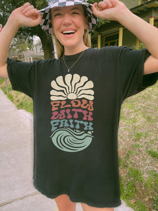 T-shirt with Flow With Faith text in groovy wavy font with retro sunset and wave design
