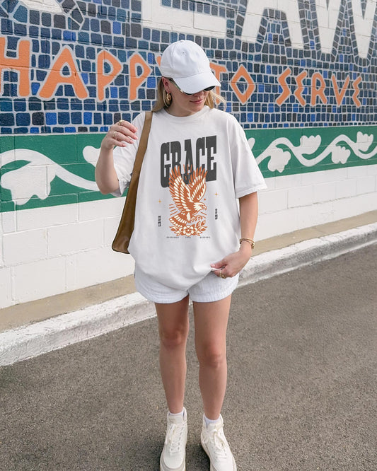 Christian t-shirt with vintage eagle design in orange and cream colors featuring Grace text and decorative elements