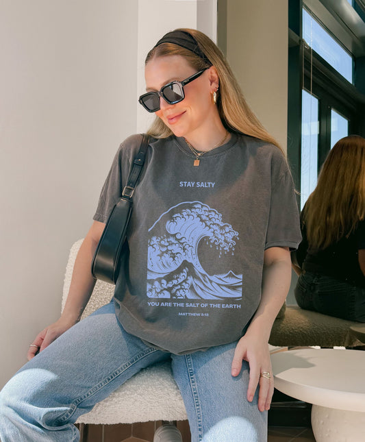 T-shirt with ocean wave design featuring Stay Salty text and Matthew 5:13 Bible verse