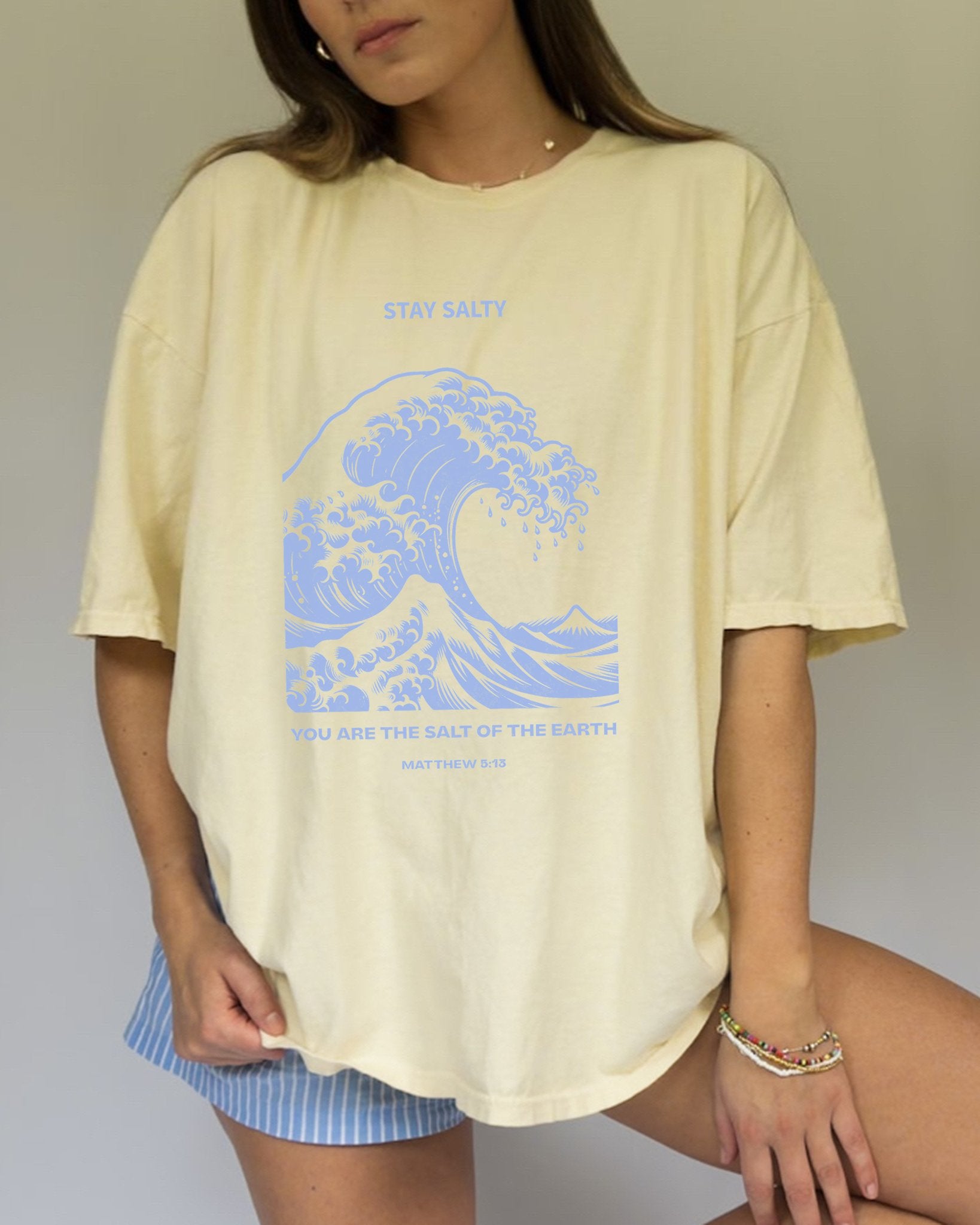T-shirt with ocean wave design featuring Stay Salty text and Matthew 5:13 Bible verse