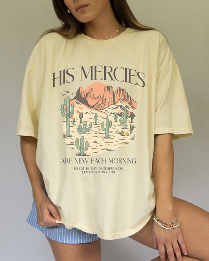 T-shirt with desert landscape design featuring cacti, mountains, and 'His Mercies Are New Each Morning' text with Lamentations 3:23 bible verse