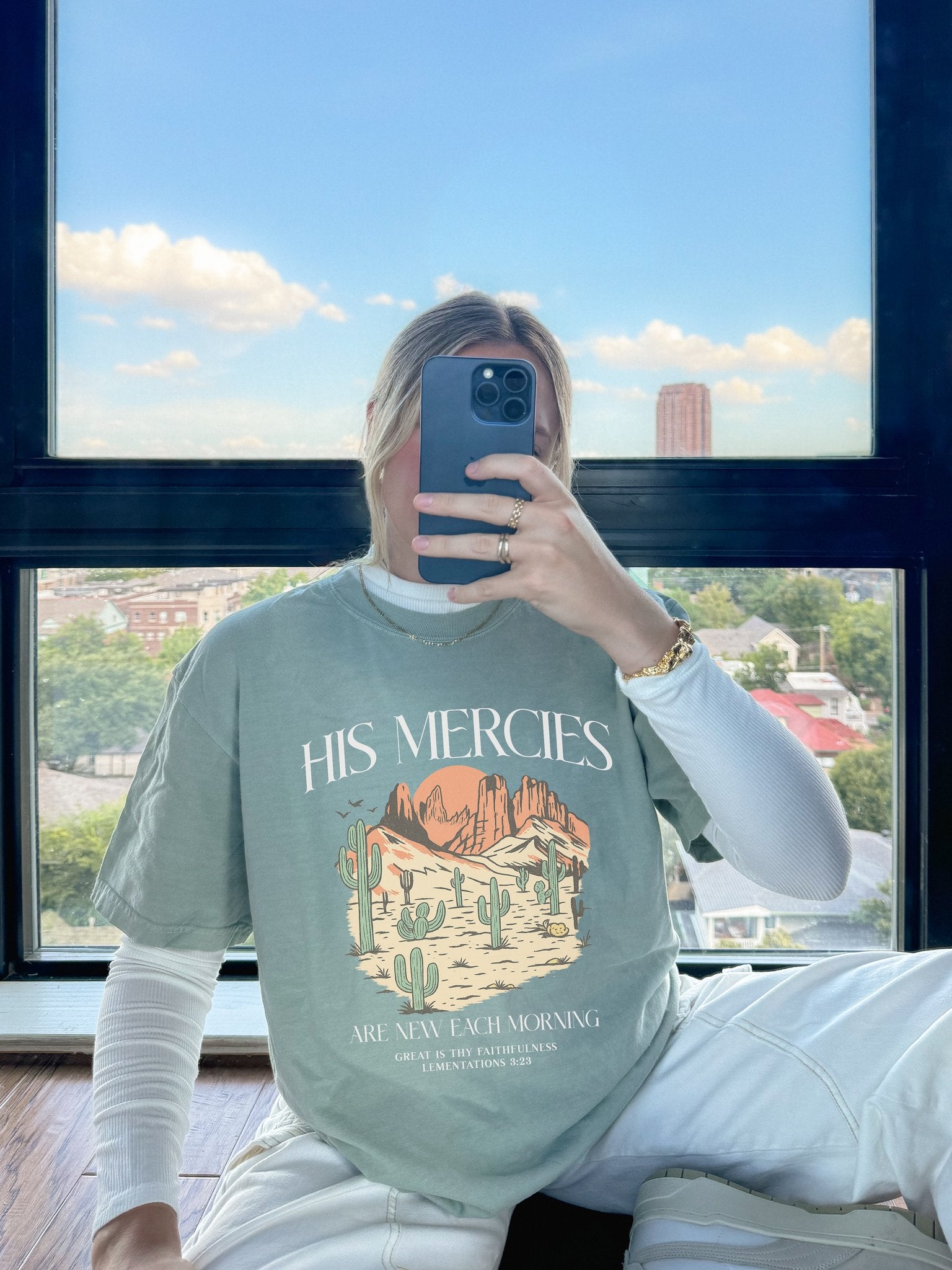 T-shirt with desert landscape design featuring cacti, mountains, and 'His Mercies Are New Each Morning' text with Lamentations 3:23 bible verse