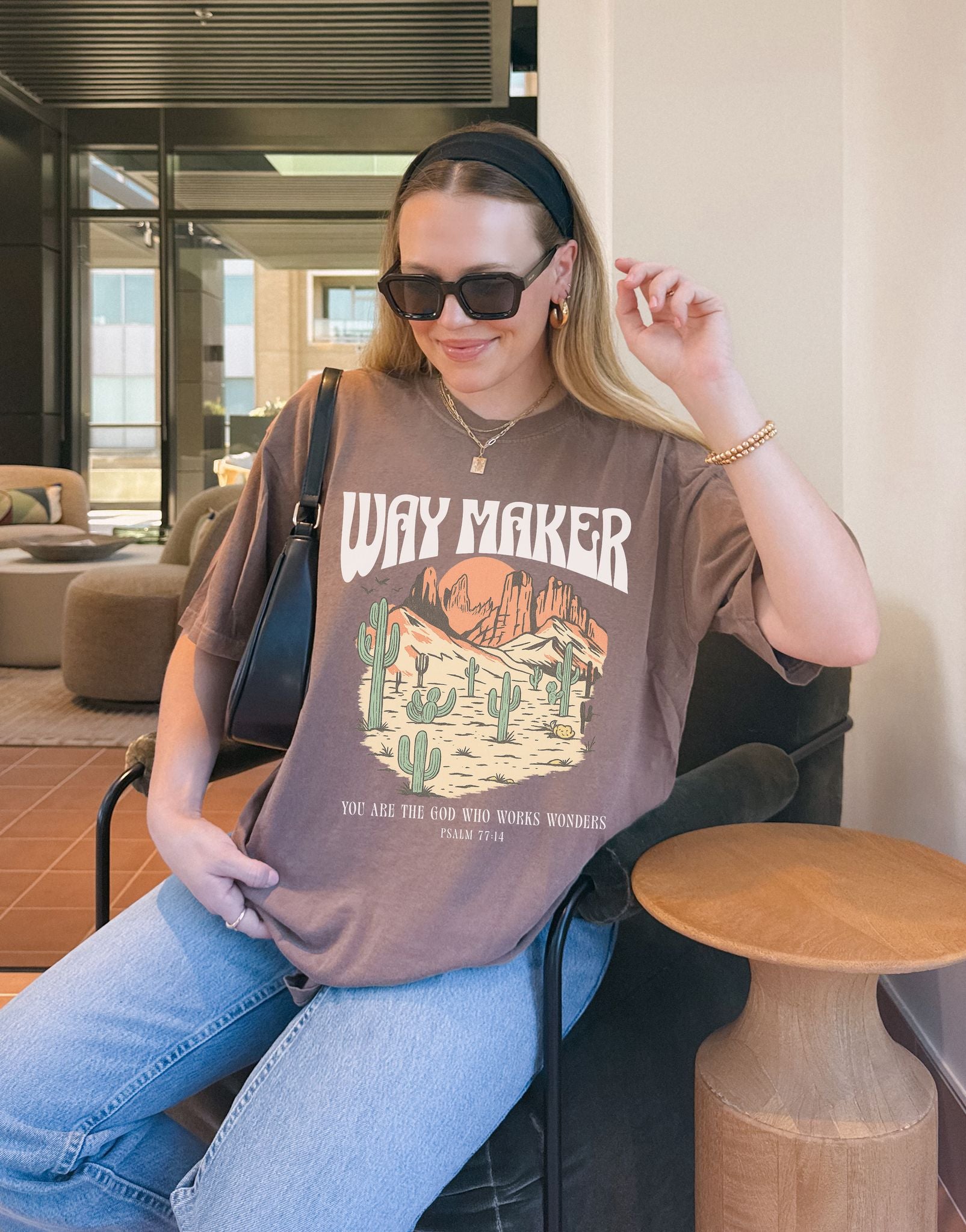 T-shirt with Way Maker text, desert landscape featuring cacti, mountains, and orange sunset with Psalm 77:14 verse