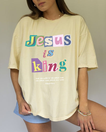 T-shirt with colorful block letters spelling Jesus is King and Psalm 95:3 Bible verse