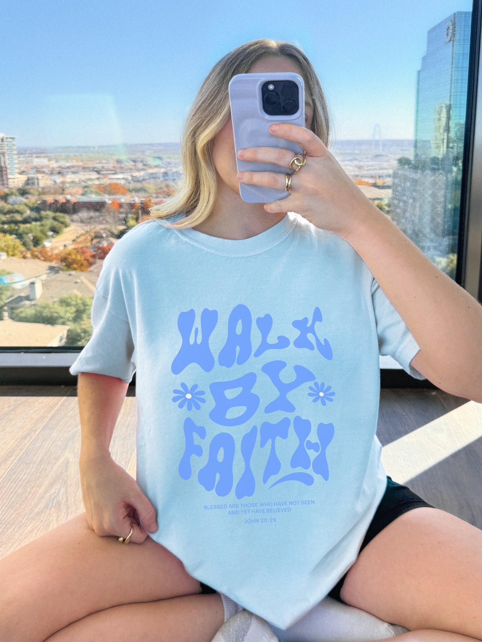 T-shirt with retro wavy font reading 'Walk By Faith' in blue letters with flower accents and John 20:29 scripture