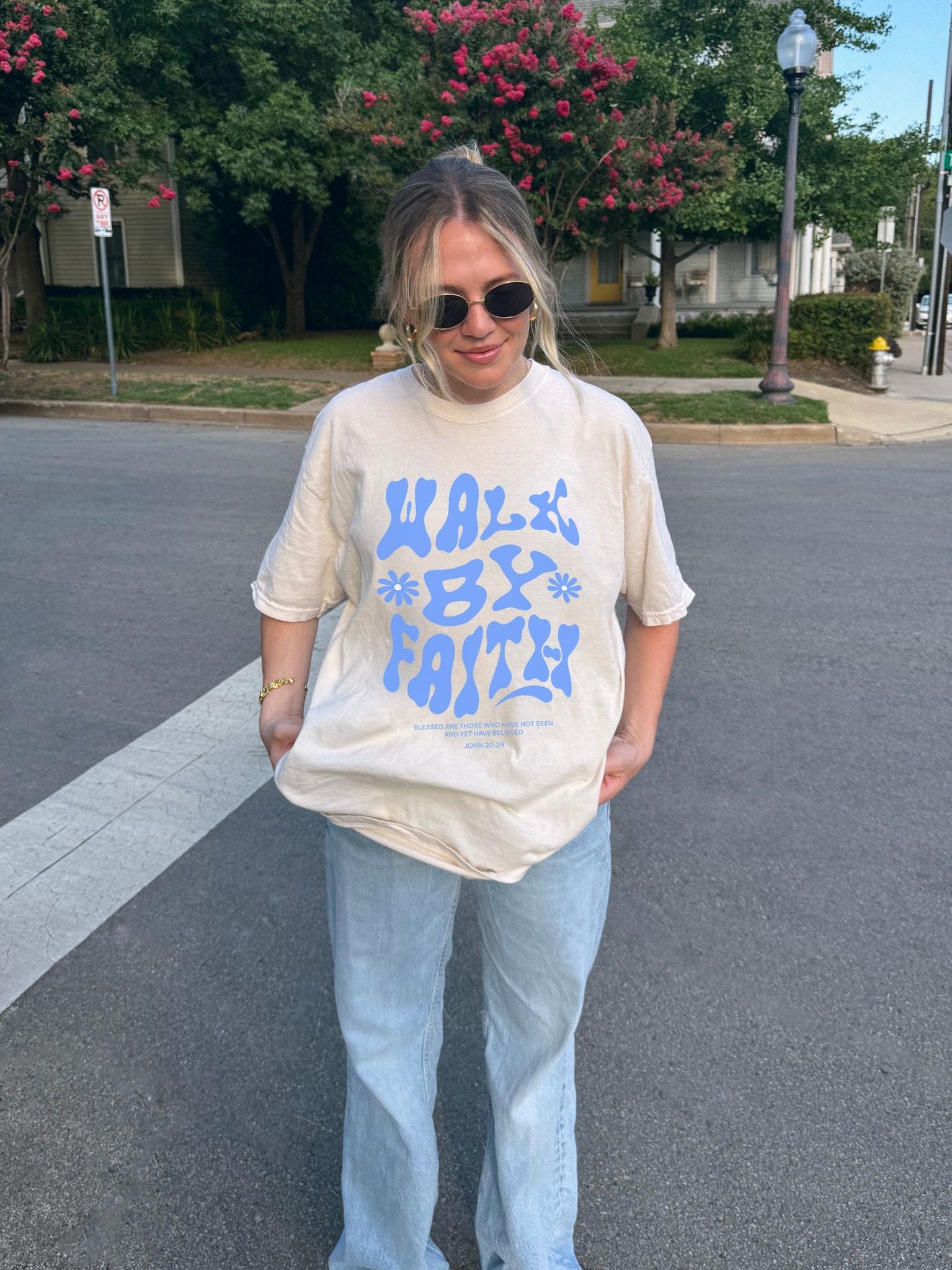 T-shirt with retro wavy font reading 'Walk By Faith' in blue letters with flower accents and John 20:29 scripture
