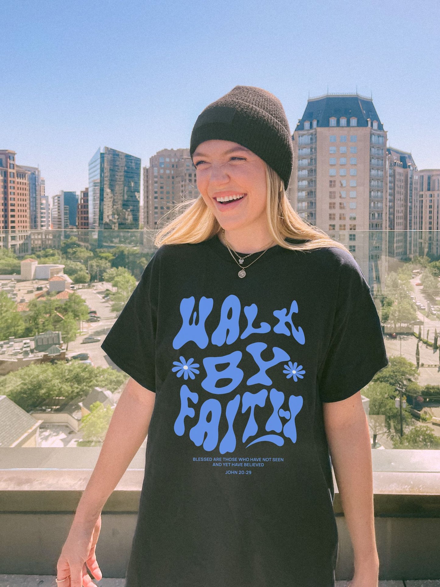 T-shirt with retro wavy font reading 'Walk By Faith' in blue letters with flower accents and John 20:29 scripture