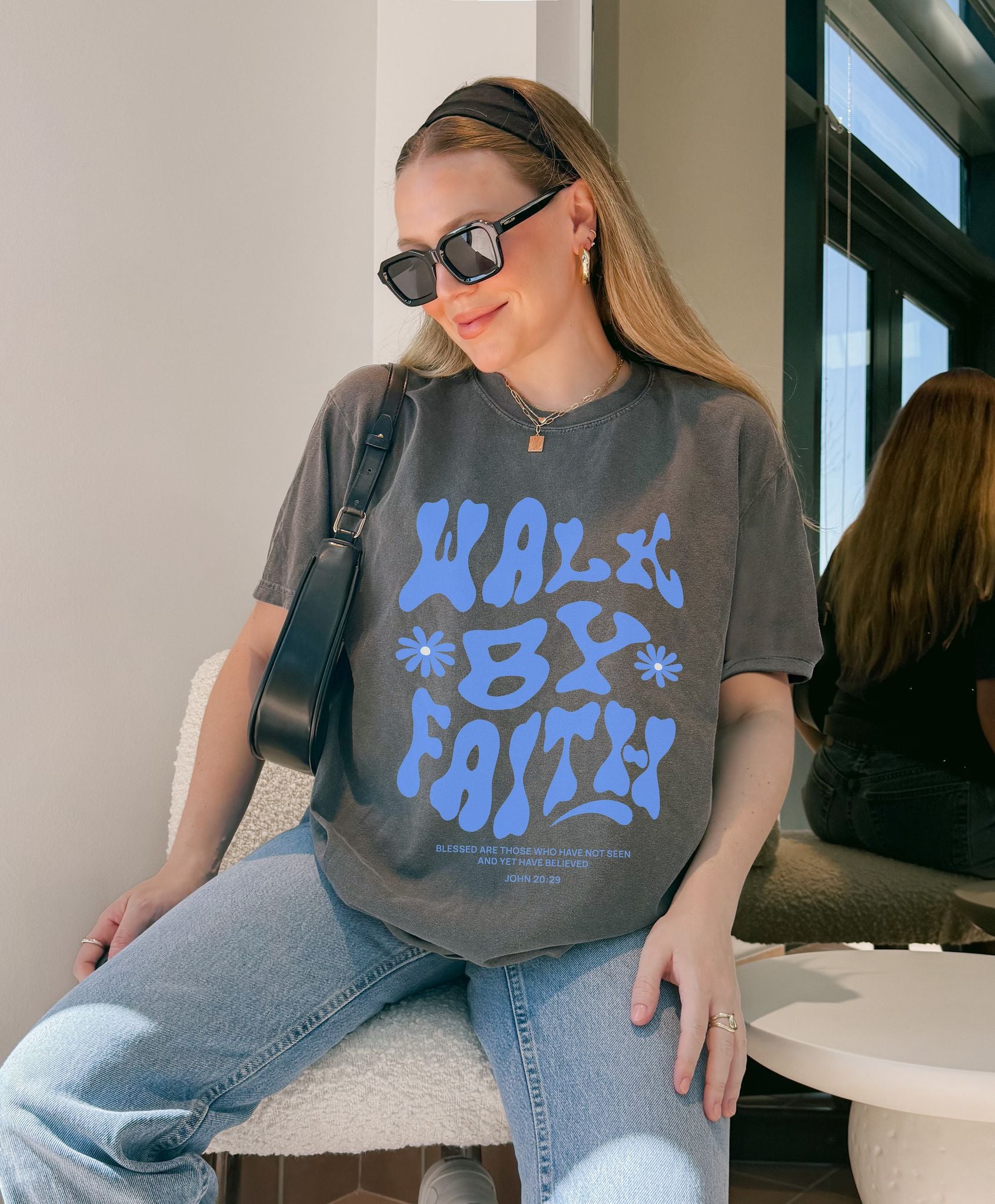 T-shirt with retro wavy font reading 'Walk By Faith' in blue letters with flower accents and John 20:29 scripture