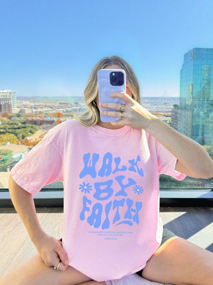 T-shirt with retro wavy font reading 'Walk By Faith' in blue letters with flower accents and John 20:29 scripture