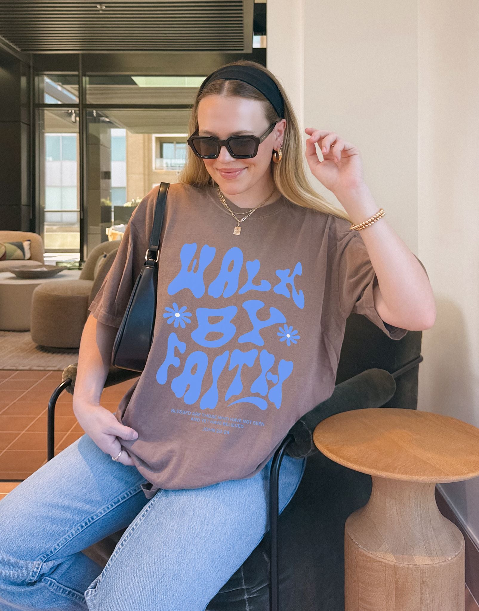 T-shirt with retro wavy font reading 'Walk By Faith' in blue letters with flower accents and John 20:29 scripture