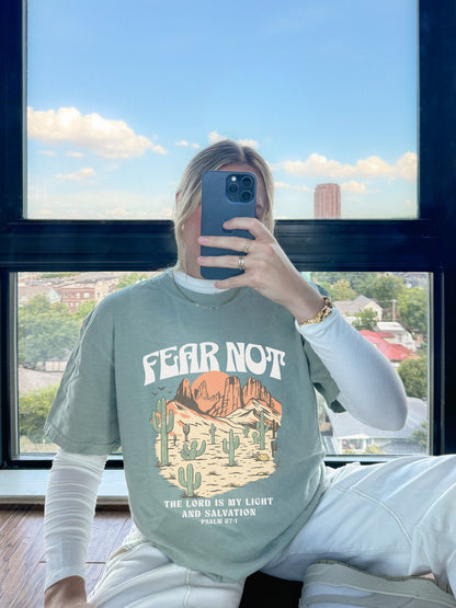 T-shirt with Fear Not text above desert scene with cacti, red rocks, and Psalm 27:1 verse below