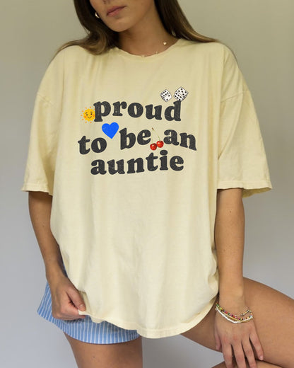 T-shirt with distressed text 'proud to be an auntie' featuring sun, heart, dice and cherries