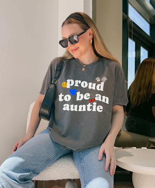 T-shirt with distressed text 'proud to be an auntie' featuring sun, heart, dice and cherries