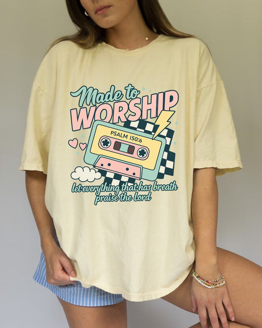 T-shirt with retro cassette tape design featuring 'Made to Worship' text and Psalm 150:6 scripture in pastel colors
