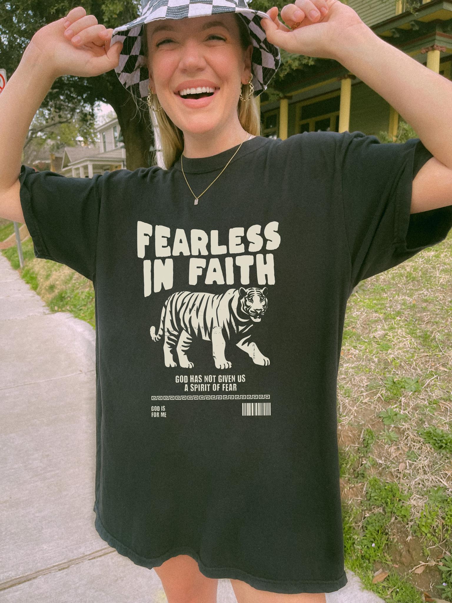 A t-shirt featuring 'Fearless In Faith' text design in elegant cream colored typography