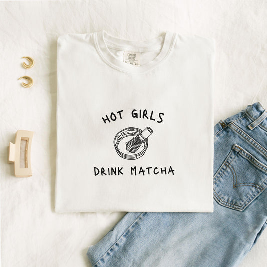 T-shirt with 'Hot Girls Drink Matcha' text and hand-drawn matcha bowl with whisk illustration