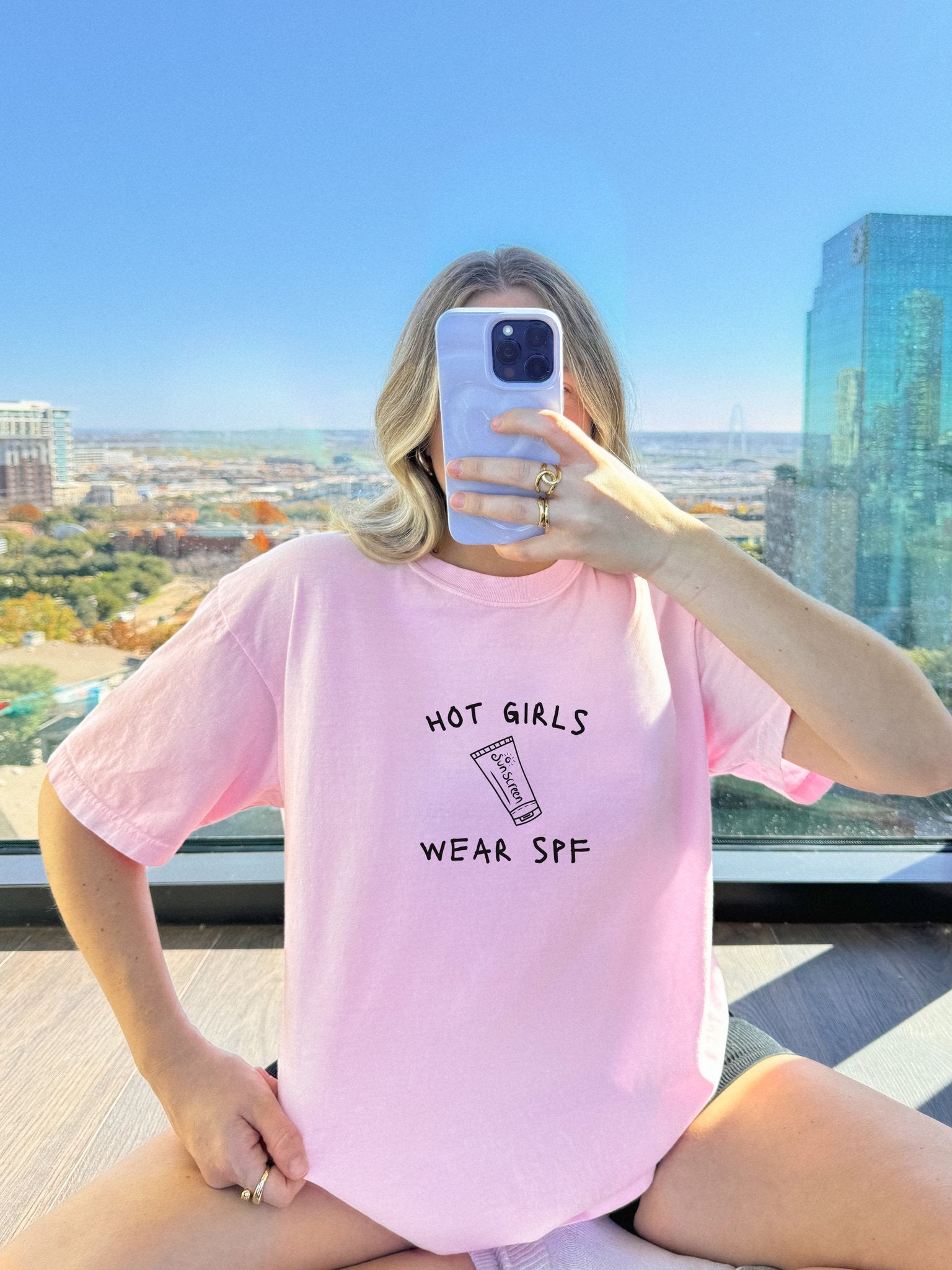 T-shirt with 'Hot Girls Wear SPF' text and sunscreen tube graphic in black minimalist design