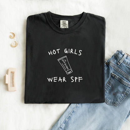 T-shirt with 'Hot Girls Wear SPF' text and sunscreen tube graphic in black minimalist design