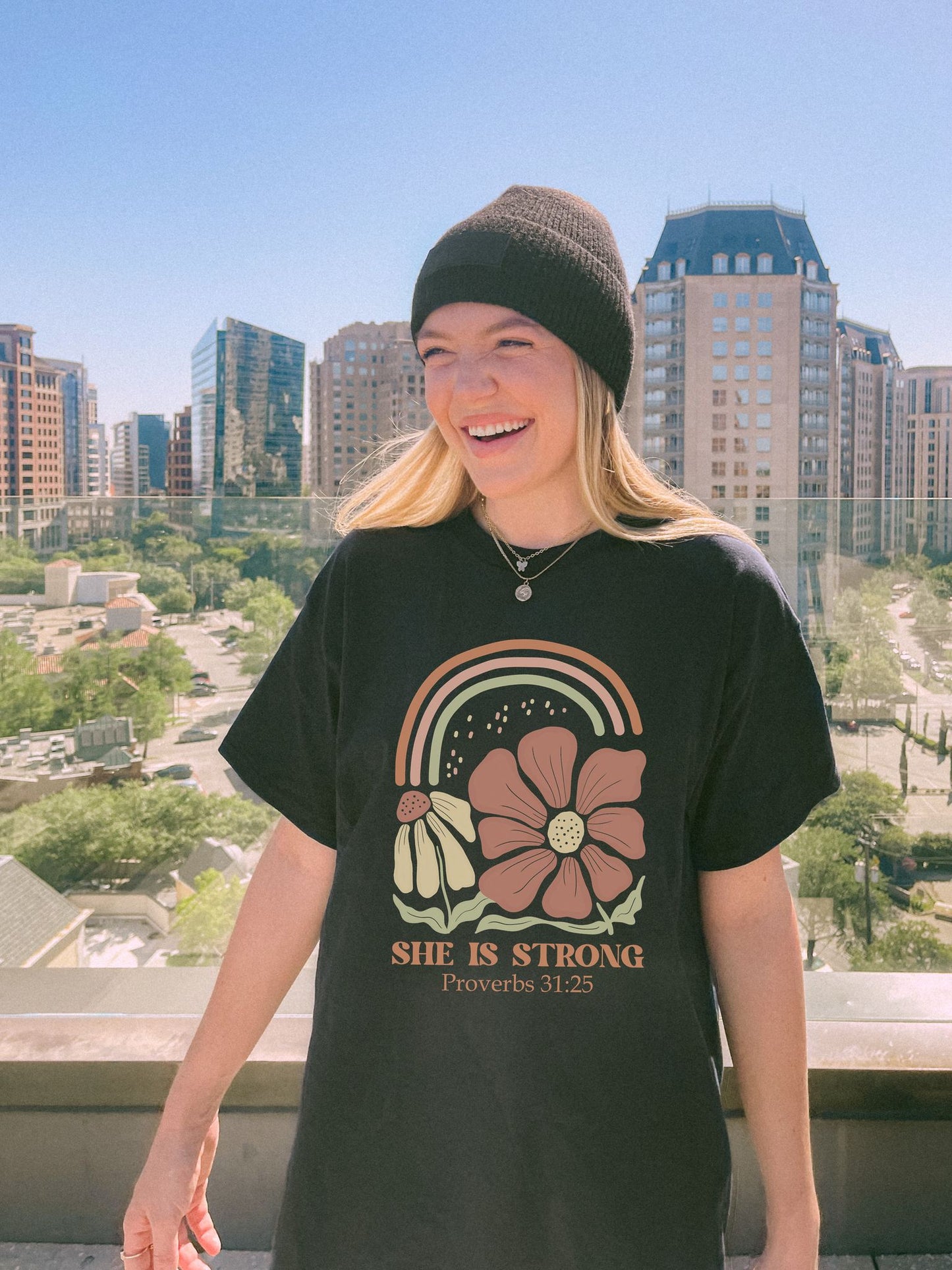 T-shirt with boho rainbow, terracotta and cream flowers, and 'She Is Strong Proverbs 31:25' text