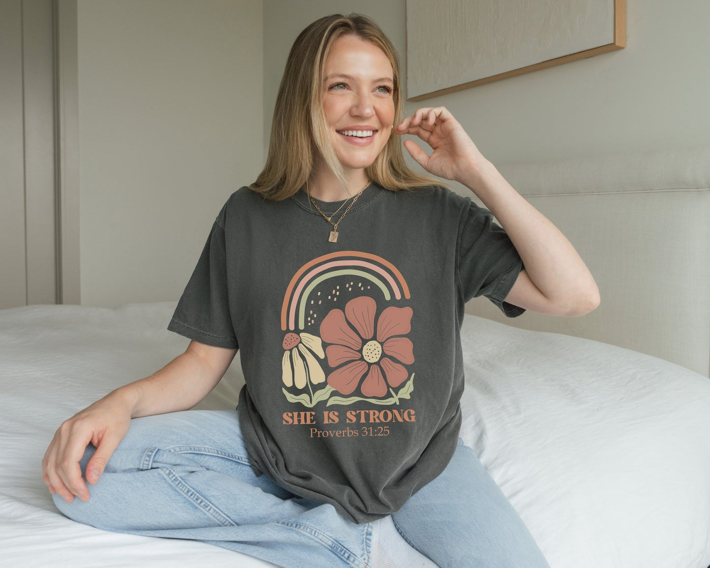 T-shirt with boho rainbow, terracotta and cream flowers, and 'She Is Strong Proverbs 31:25' text