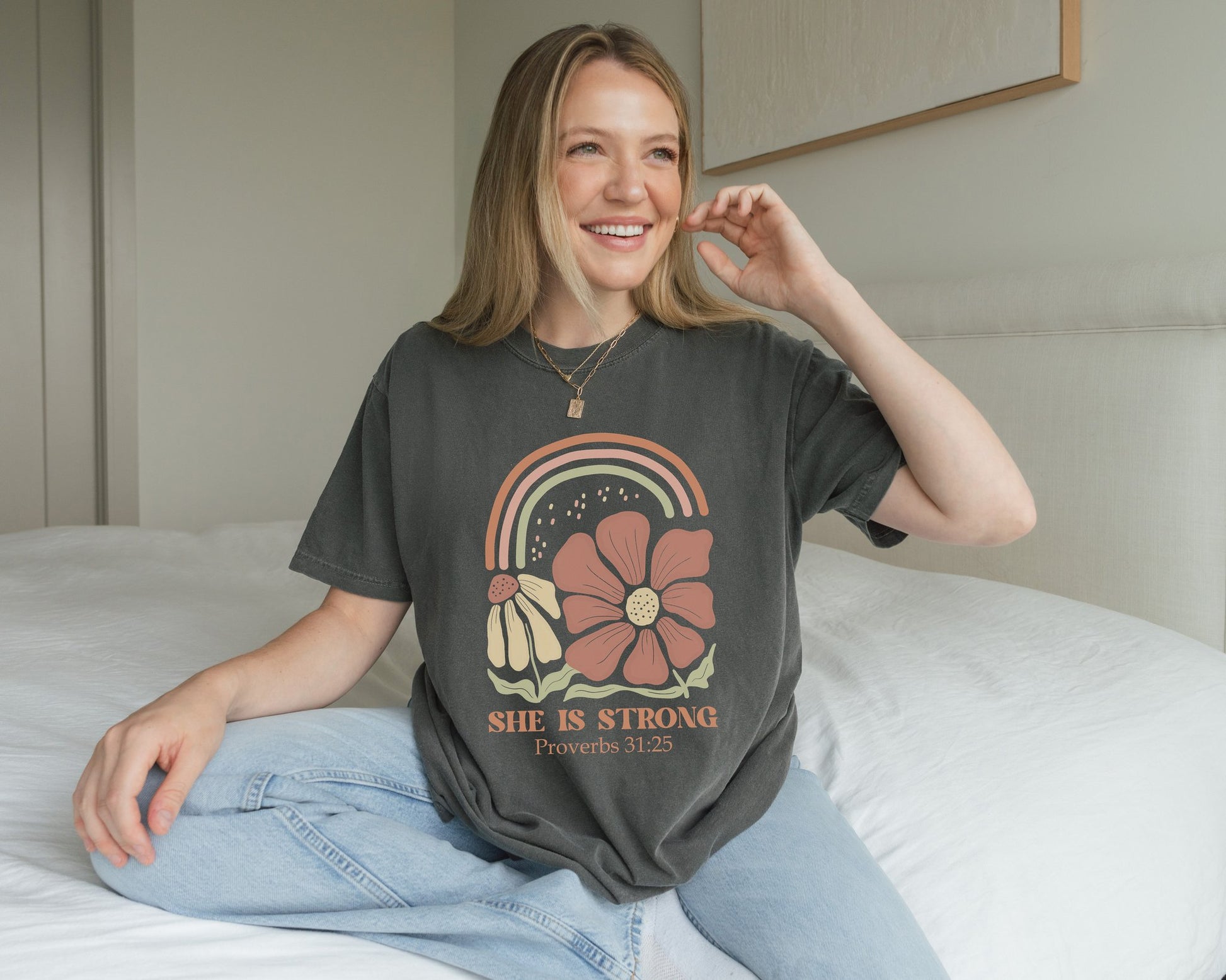 T-shirt with boho rainbow, terracotta and cream flowers, and 'She Is Strong Proverbs 31:25' text